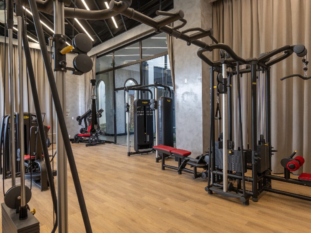 Phòng gym tại K-Town Resort Phan Thiết với máy kéo cáp và thiết bị tập sức mạnh